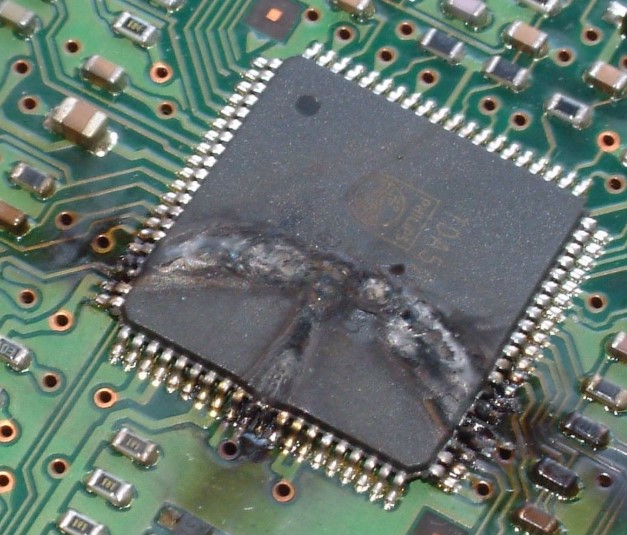 QFP IC package with a large rupture and melted plastic across its top